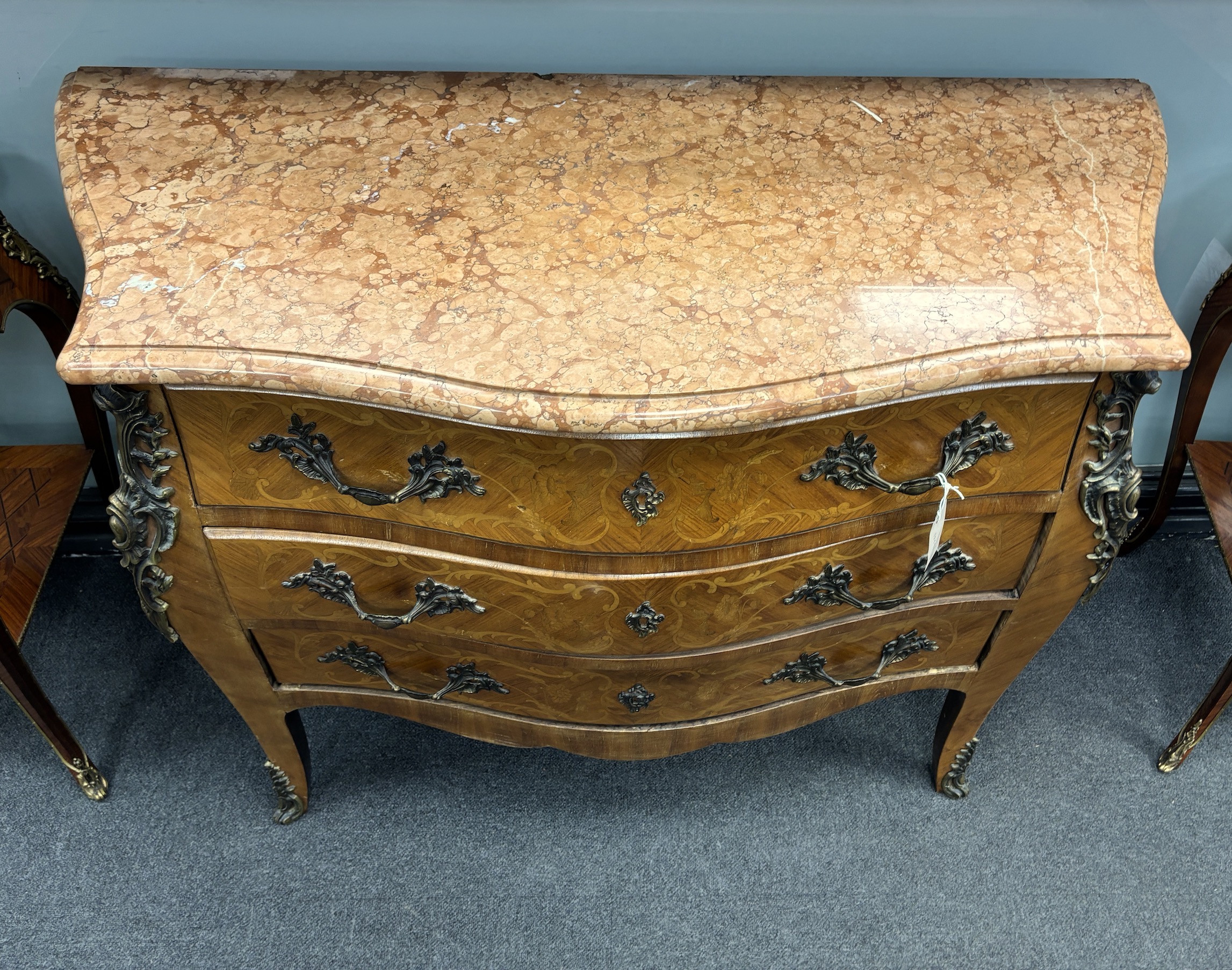 A Louis XV style gilt metal mounted marquetry inlaid marble topped bombe commode, width 118cm, depth 51cm, height 88cm